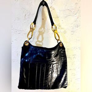 Andre Oliver designer shoulder bag with gorgeous gold chrome hardware